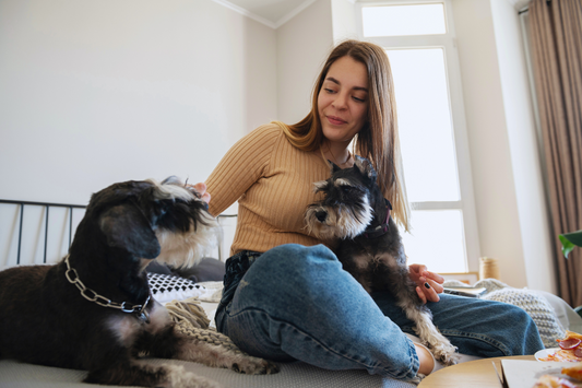 Woman with two dogs enjoying fresh air in her home
