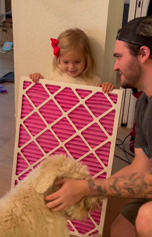 Customer holding their pet next to a Colorfil air filter